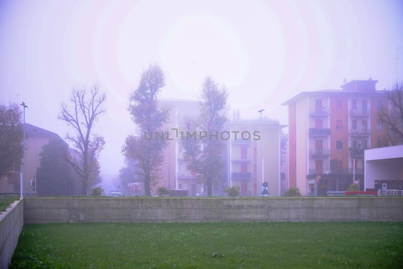 Cremona, Lombardy, Italy - November 7th 2024 Fog obscures apartment buildings and trees in a quiet residential neighborhood