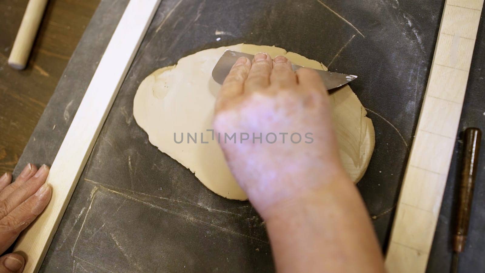 A person skillfully working with clay, demonstrating the intricate and delicate process of sculpting art. Stock Clip