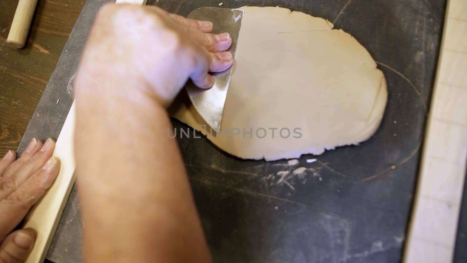 A person skillfully working with clay, demonstrating the intricate and delicate process of sculpting art. Stock Clip