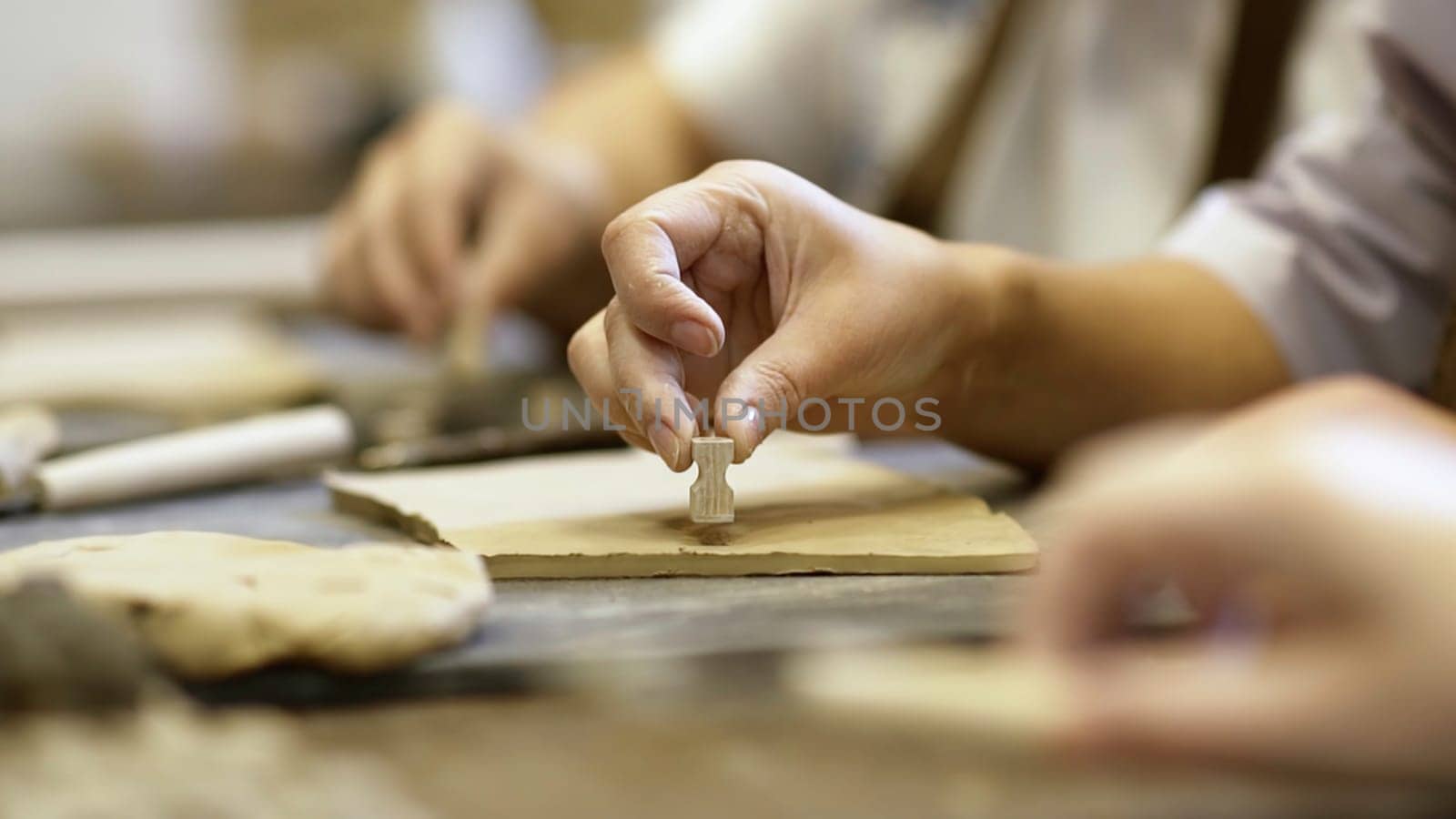 A closeup view showcasing highly skilled hands meticulously shaping clay within an artistic workspace environment. Stock Clip