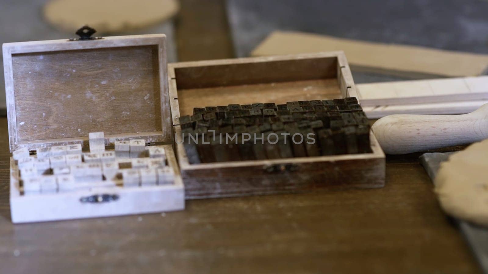 Antique letterpress blocks beautifully stored in a charming wooden box, perfect for vintage printing projects. Stock Clip