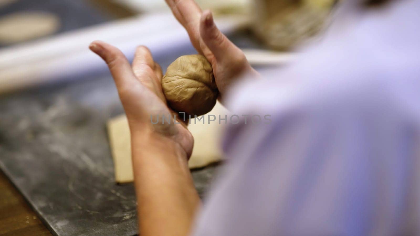 Creative Hands Engaged in the Art of Crafting Pottery During a Fun and Inspiring Class. Stock Clip
