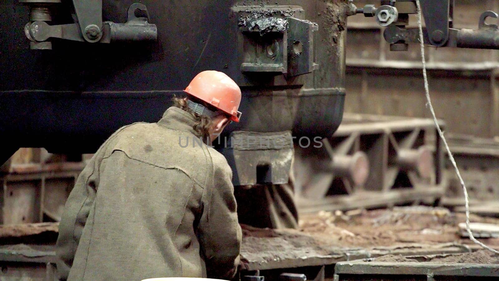 A skilled worker operates complex machinery in a factory, demonstrating dedication and exceptional craftsmanship. Stock Clip