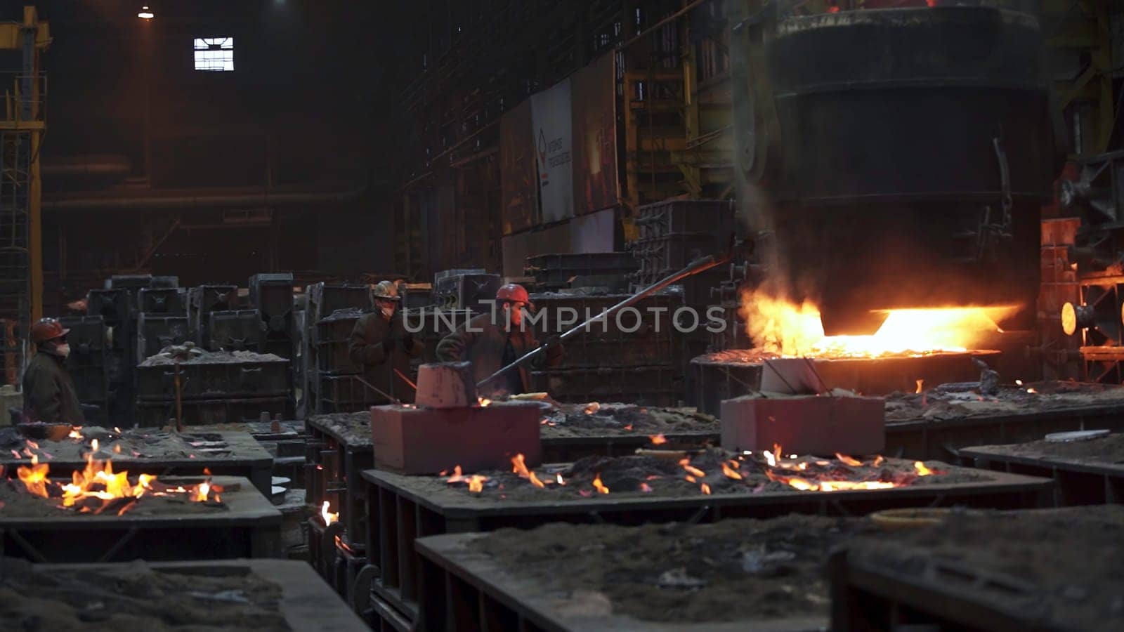 A captivating image showcasing the intricate steel production process taking place within a large industrial foundry. Stock Clip