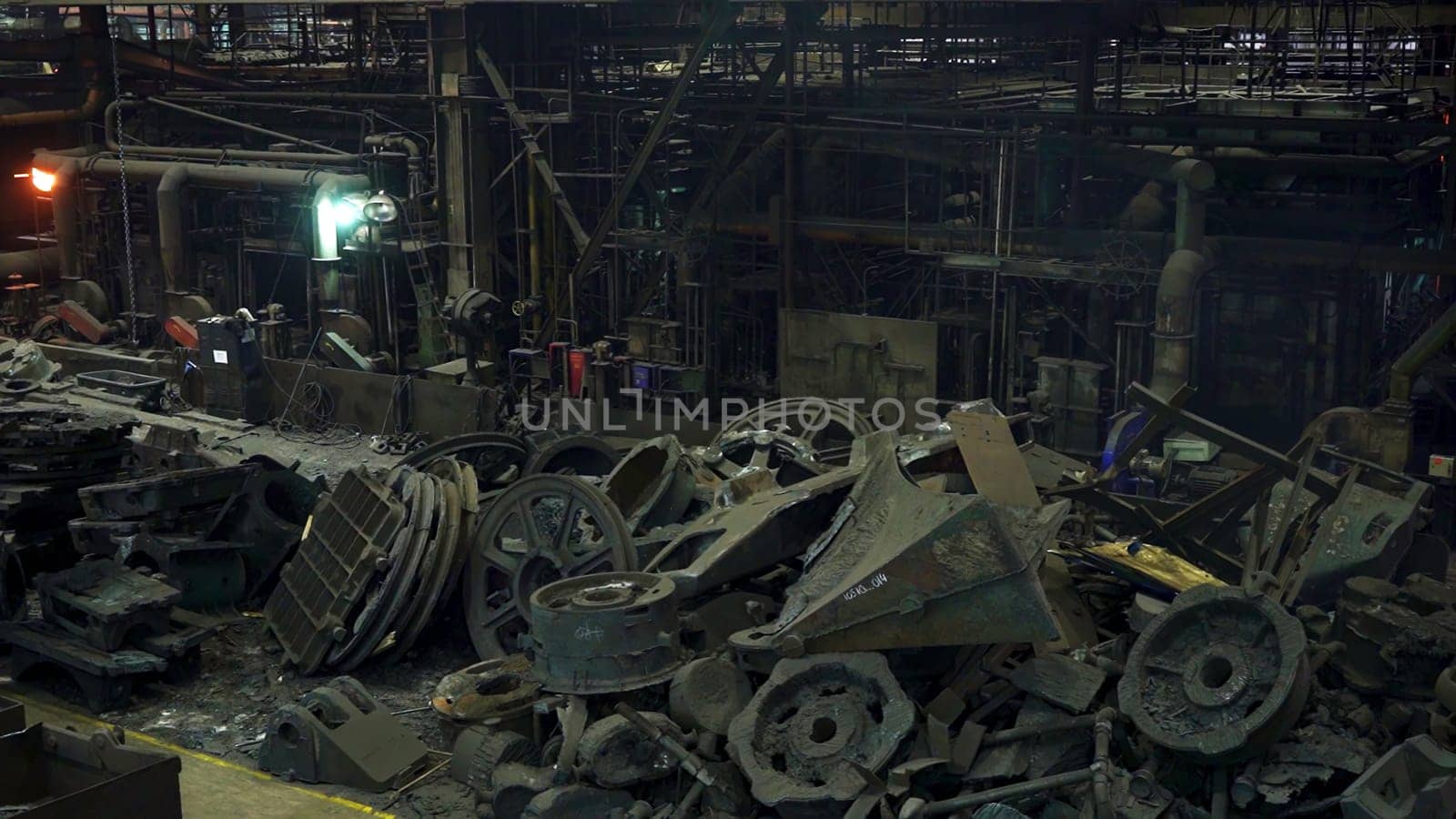 A haunting and eerie view of a derelict factory that is filled with rusted machinery and various debris. Stock Clip