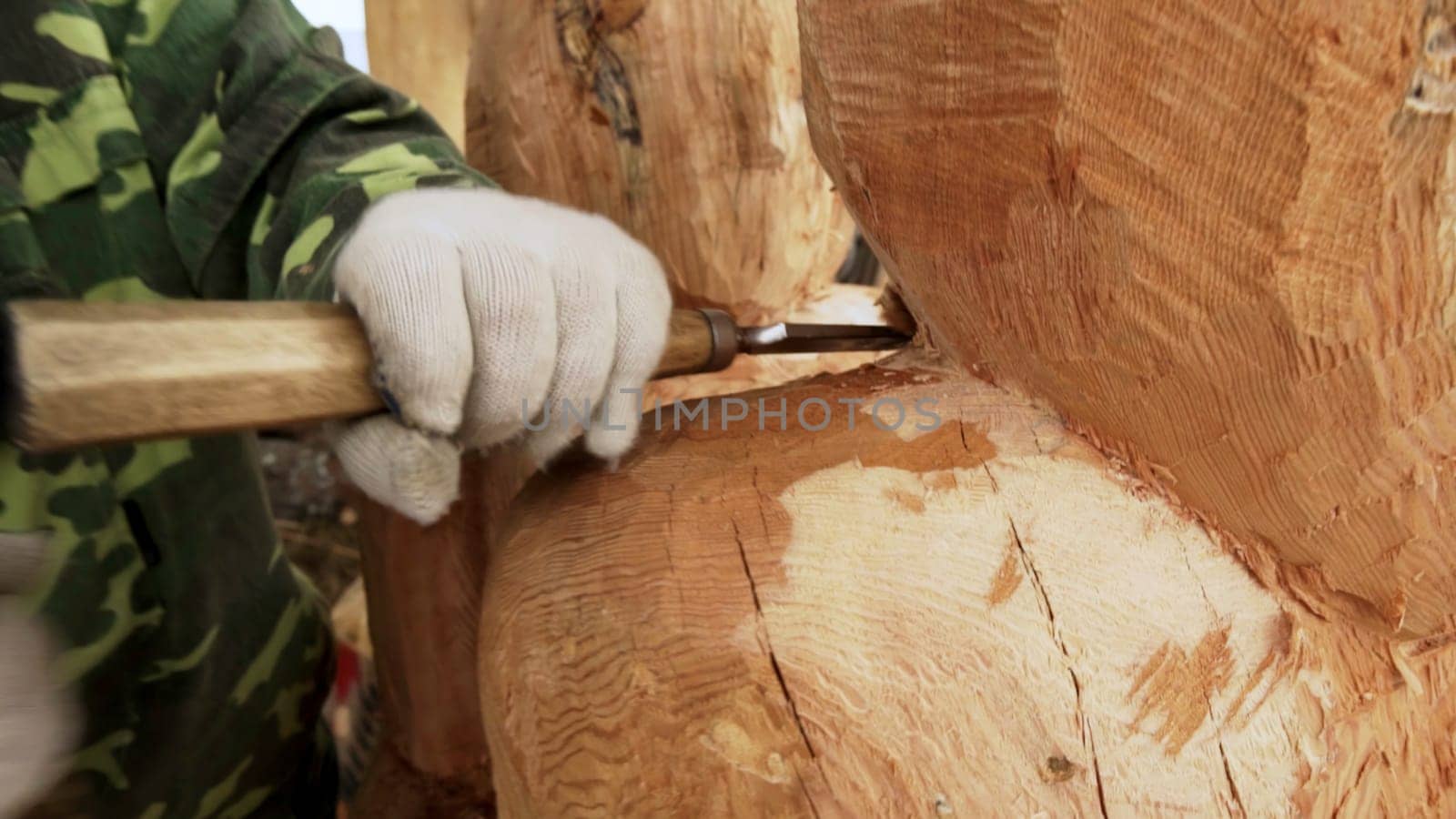 A skilled artisan carves a beautiful wooden sculpture, showcasing remarkable creativity and craftsmanship. Stock Clip