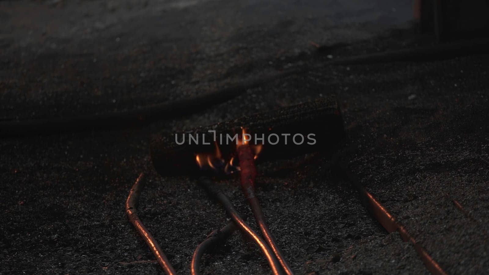 Damaged and exposed wires igniting, vividly showcasing significant fire hazards in dark and dim surroundings. Stock Clip