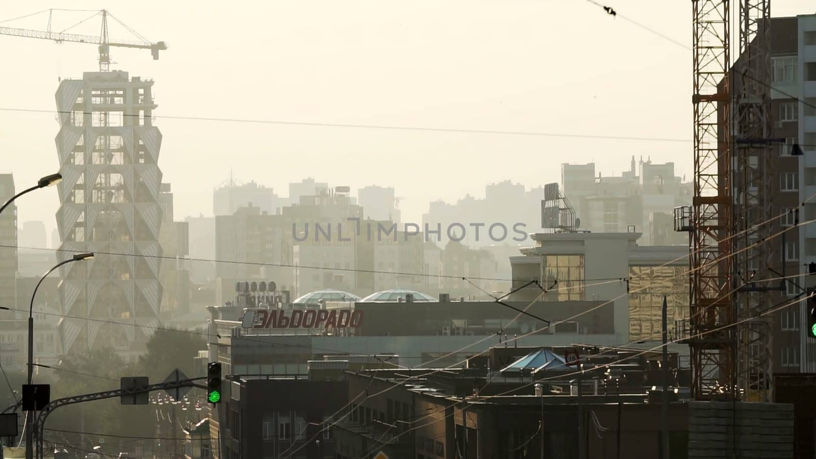 Tbilisi, Georgia - September 29, 2023: An expansive city skyline revealing dynamic construction activity taking place amidst a hazy atmosphere all around. Stock Clip