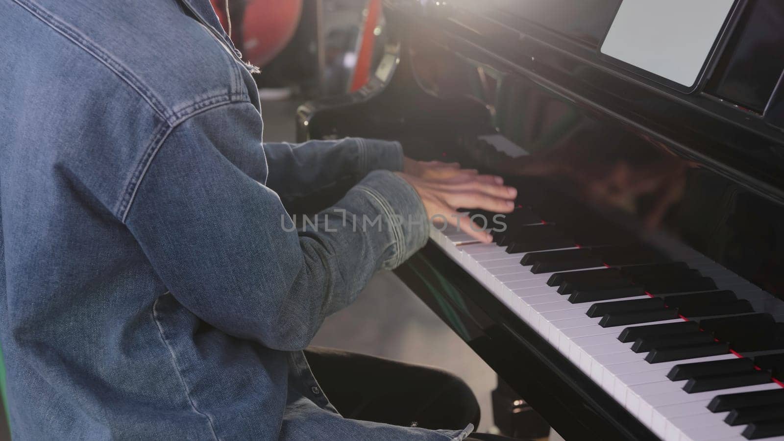A talented musician plays the piano creatively, showcasing their skill and artistry in a unique environment. Clip