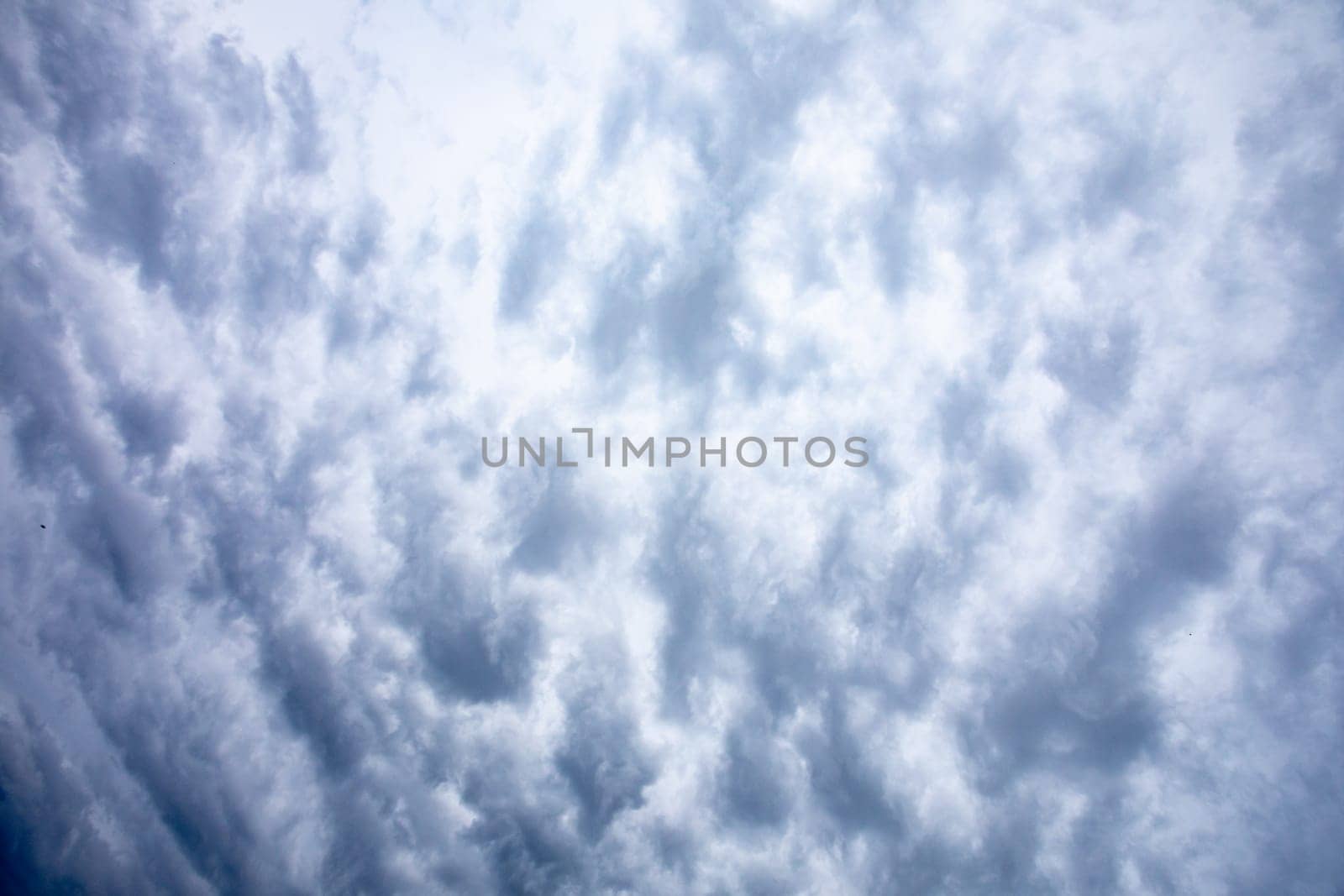 A captivating view of dynamic cloud formations in a brilliant blue sky, ideal for creating emotional visuals