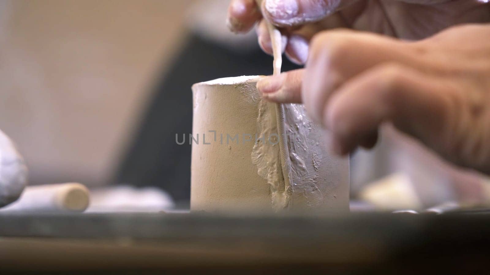 A close up of skilled hands expertly shaping and crafting clay pottery in a beautifully artistic studio setting. Stock Clip