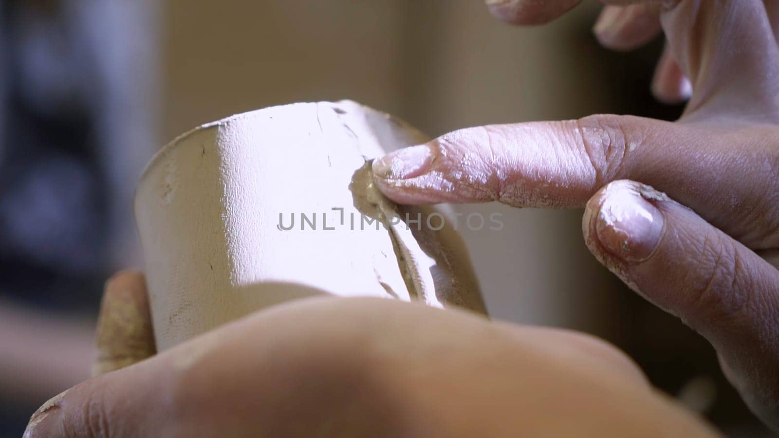 A highly skilled artisan expertly shaping soft clay, showcasing the intricate and beautiful details of pottery making. Stock Clip
