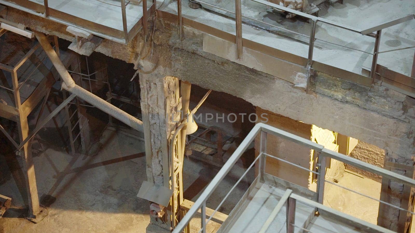 An industrial scene featuring metal structures and illuminated spaces, showcasing raw architectural elements. Stock Clip