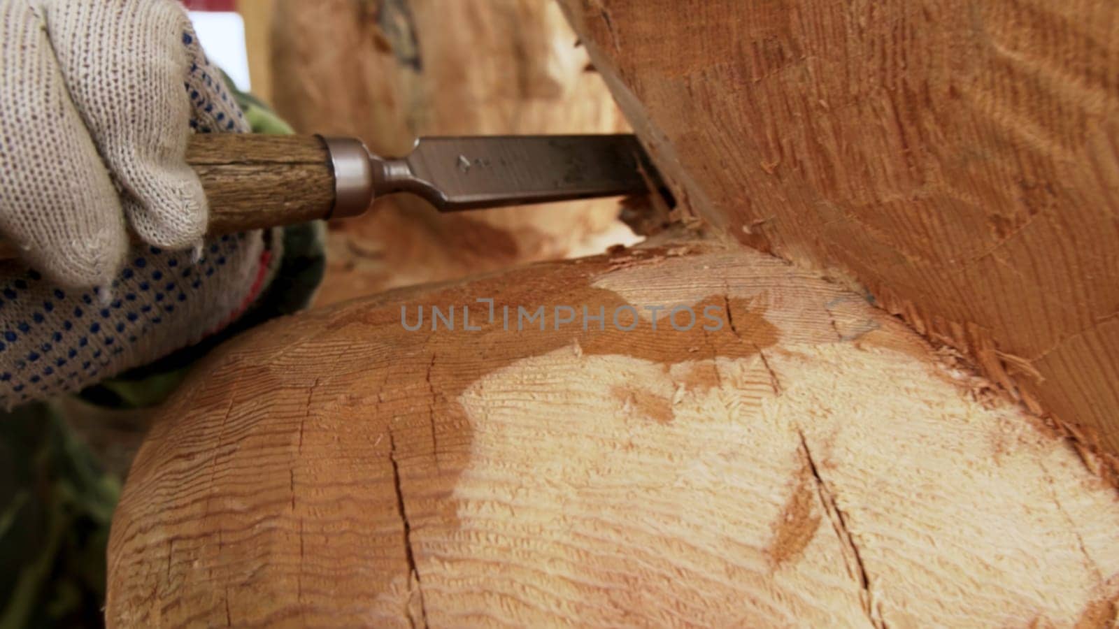A skilled artisan carves a beautiful wooden sculpture, showcasing remarkable creativity and craftsmanship. Stock Clip
