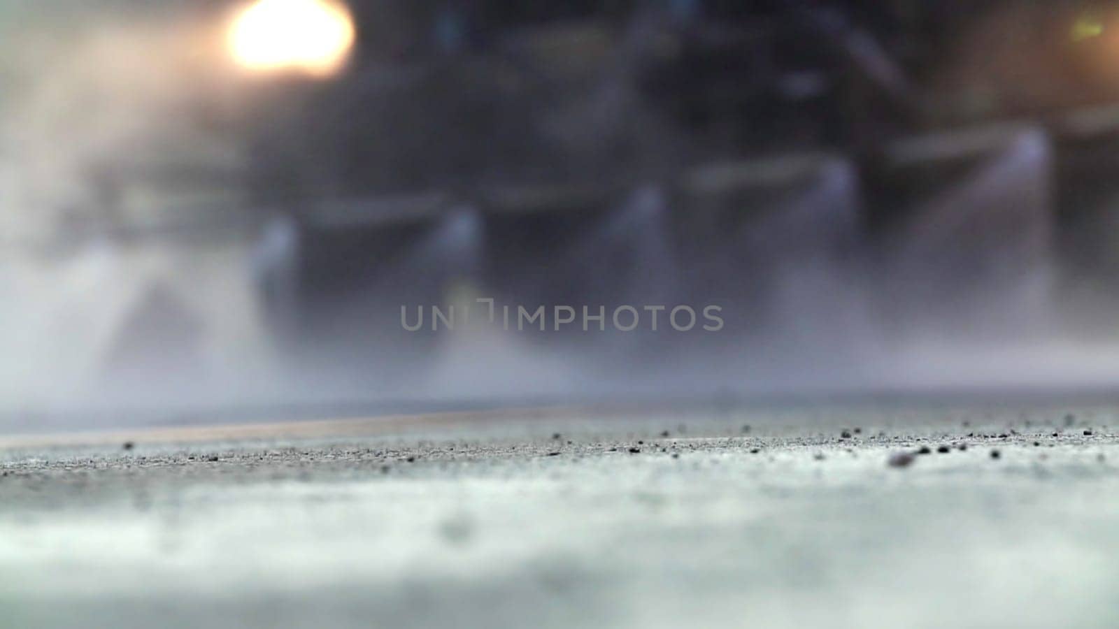 A misty street scene captures blurred motion and water spray effects, perfect for urban themed interpretations. Stock Clip