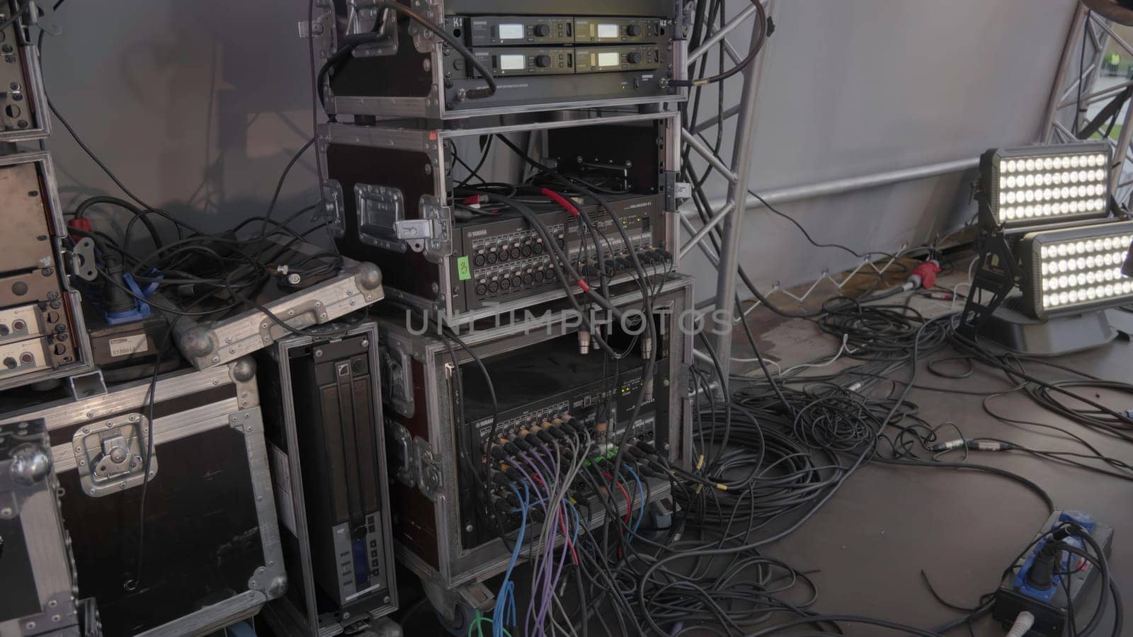 The image showcases a media setup with various equipment and tangled cables, ideal for professional events. Clip