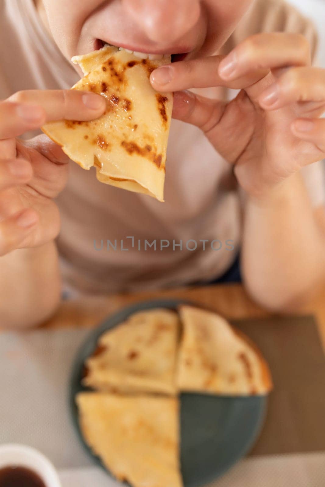 woman eating gluten-free pancakes at breakfast.