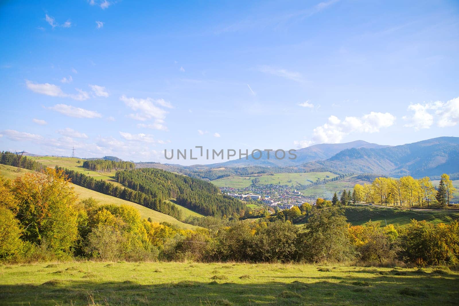 Summer landscape in mountains and the dark blue sky with clouds.