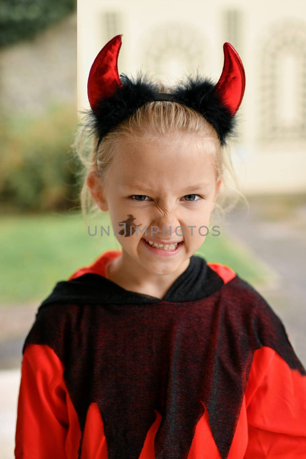 Scary girl dressed as a devil with horns