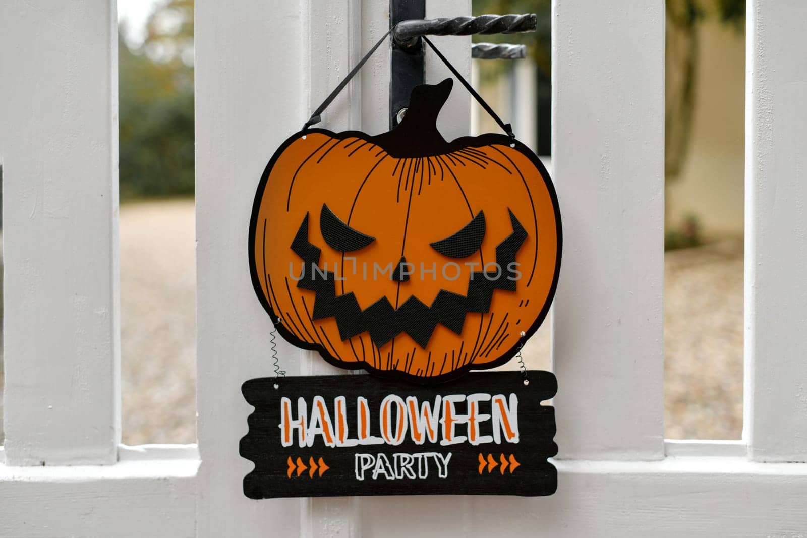 Carved pumpkin on the fence of the house