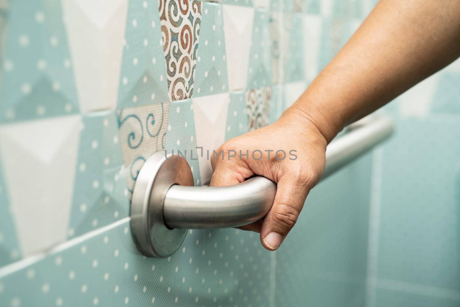 Asian elderly woman use bathroom handle security in toilet, healthy strong medical concept. by pamai