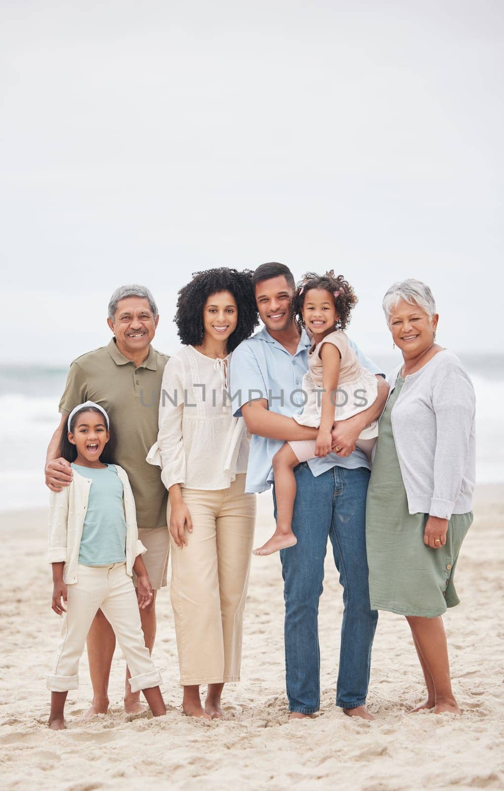 Portrait, happy and big family at beach on holiday, vacation or travel outdoor on mockup space. Parents, grandparents and kids at ocean for care, children bonding together and smile for love at sea.