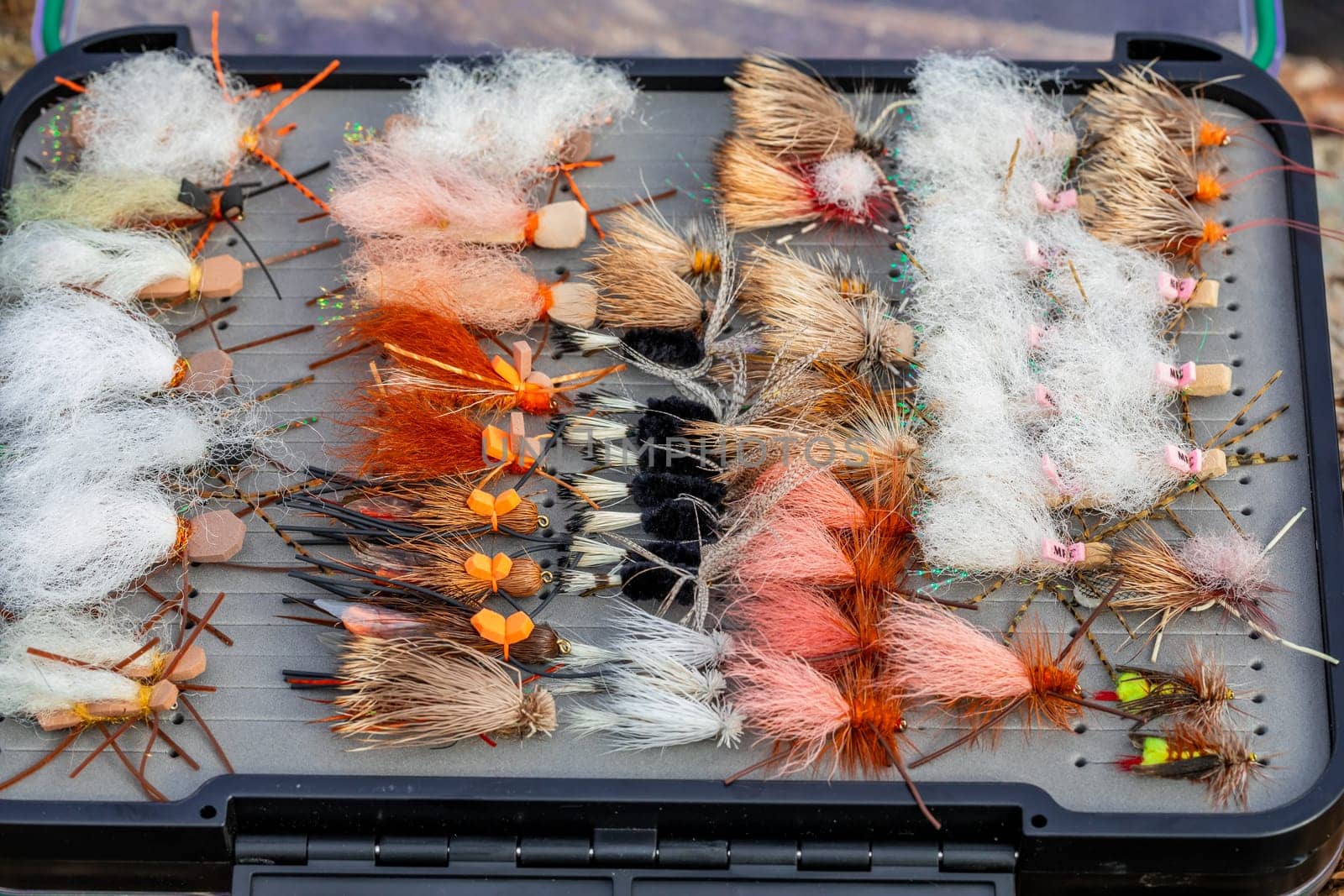 Fly box closeup detail of some flies and nymphs ready for trout fishing in the Fall in Oregon.
