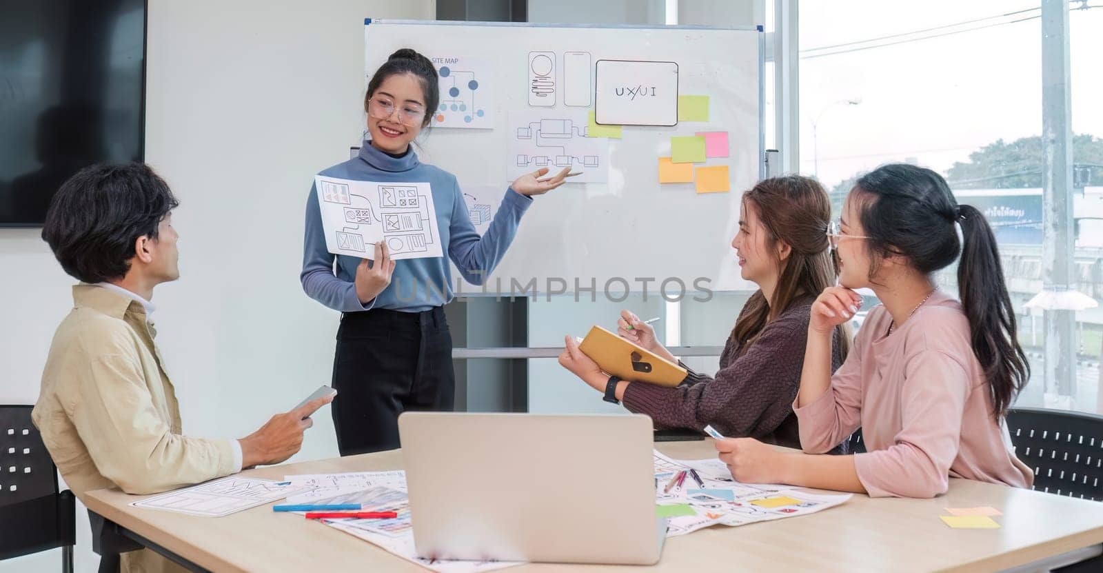 Asian office team brainstorming, plan for solution idea, Group of asian creative teamwork and woman leader at business meeting for developing mobile phone app, ux, ui start up, small business.