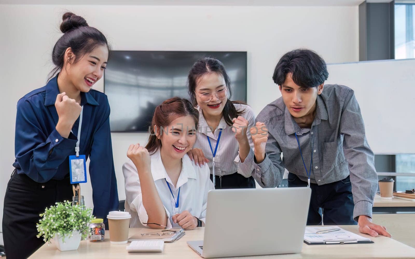 Group of Young Asian business team creative businesspeople coworker in office Happy to be successful partnership teamwork celebrating achievement and success concept..