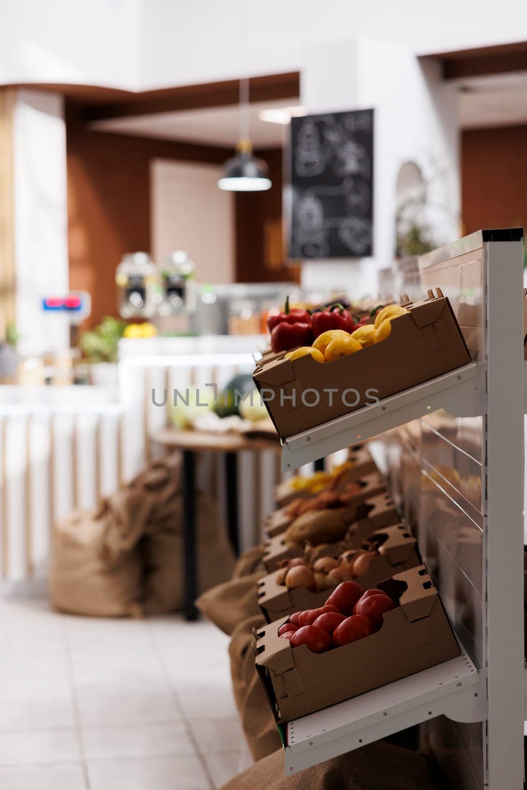 Local sourced groceries on shelves in zero waste supermarket. Bio and nutritious vegetables grown organically ready to be sold to healthy living customers in eco food shop