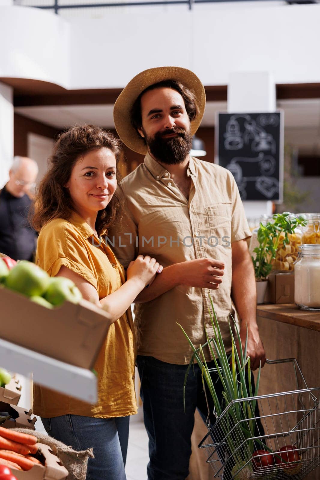 Husband and wife shopping in zero waste store, looking for healthy locally sourced bulk products. Green living couple purchasing pantry staples from local neighborhood shop