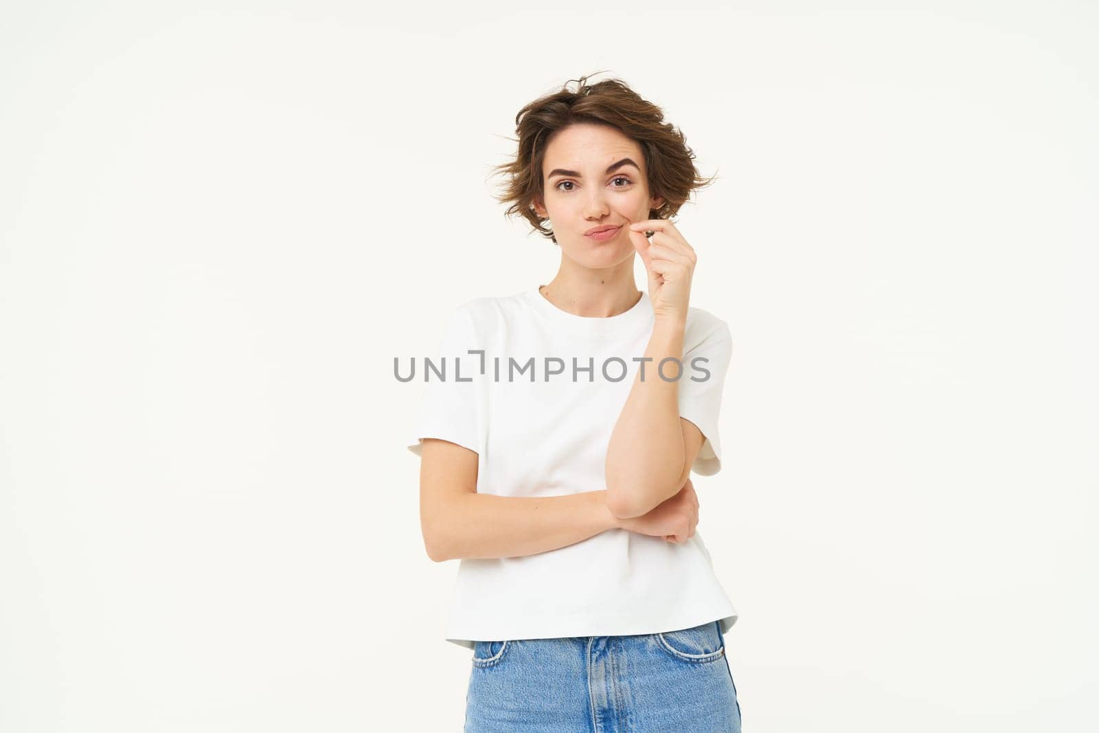Young woman shuts her mouth, zips lips on seal, makes promise to keep secret, stands over white background. Copy space