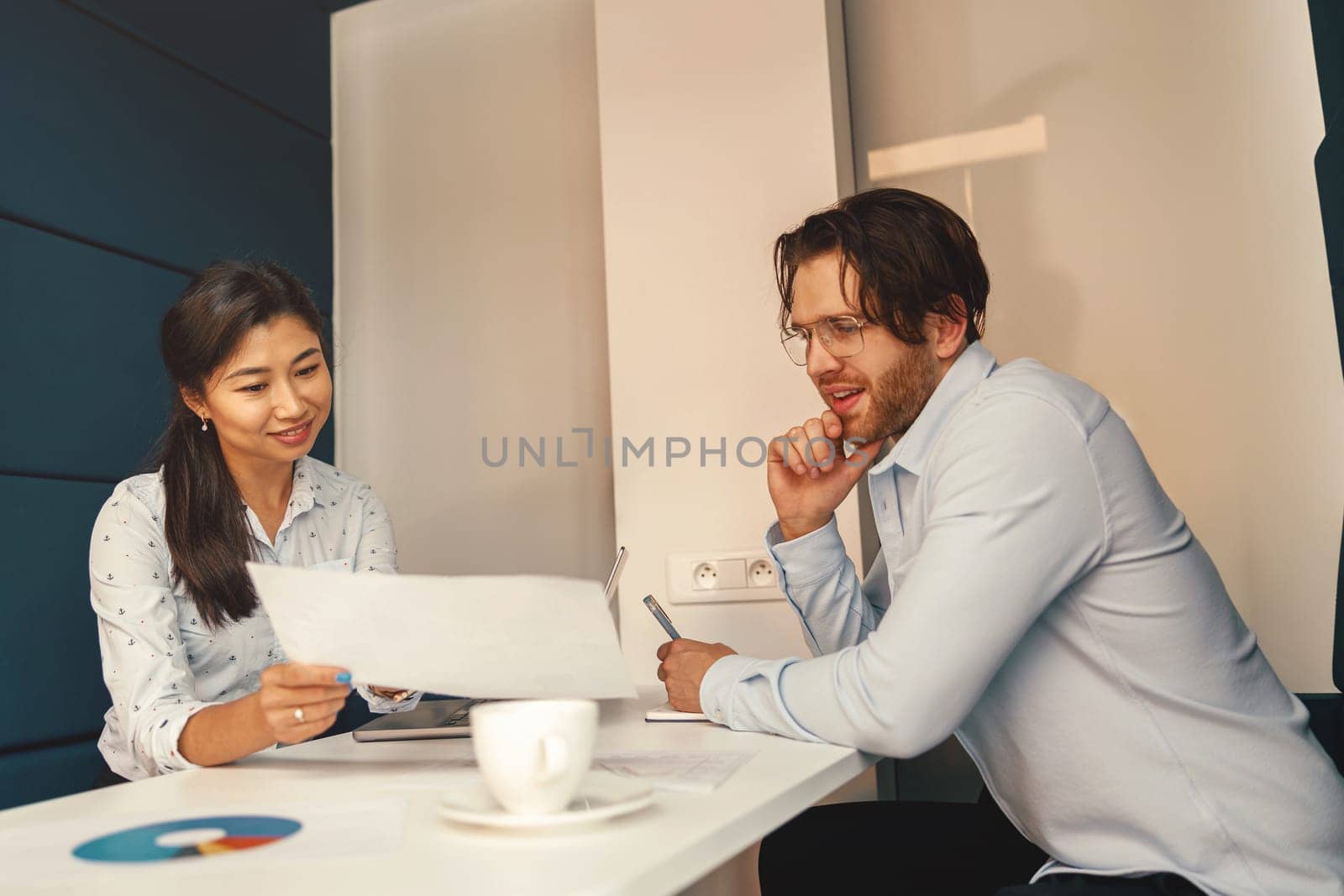 Financial analyst consult client to increase business profitability sitting in cozy coworking