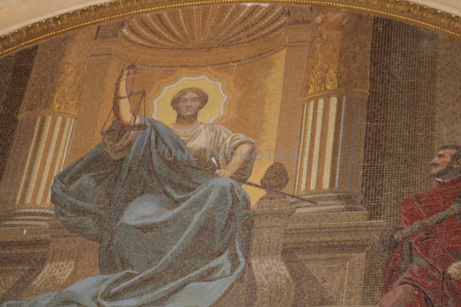 A majestic statue representing Justice sits prominently in a colorful mosaic, adorned with symbols of her authority and wisdom in a historic setting.