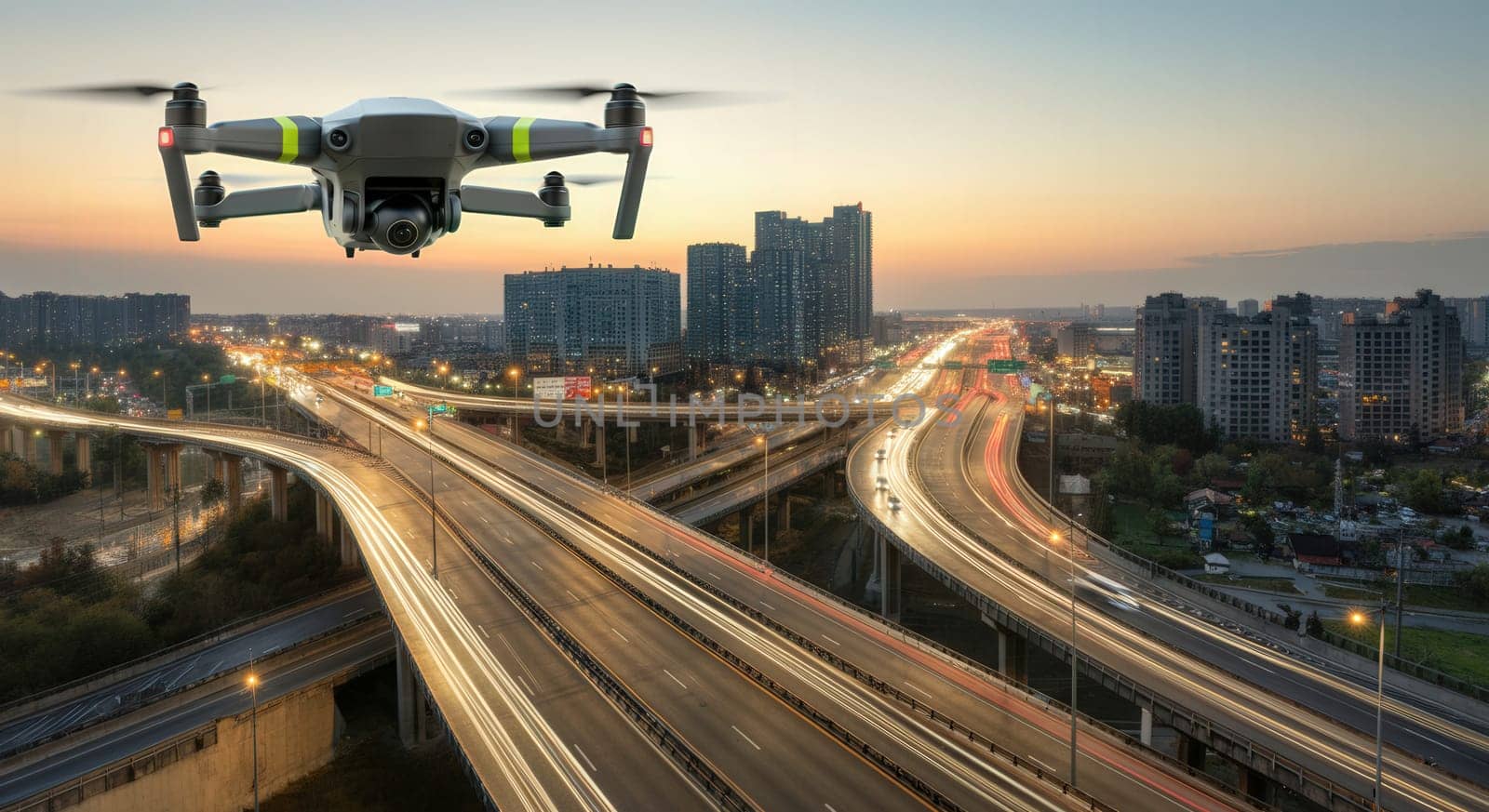 A drone hovers above a sprawling city highway interchange at sunset, capturing the flow of traffic and the dynamics of urban life. the scene highlights modern transportation infrastructure and technological surveillance in city planning.