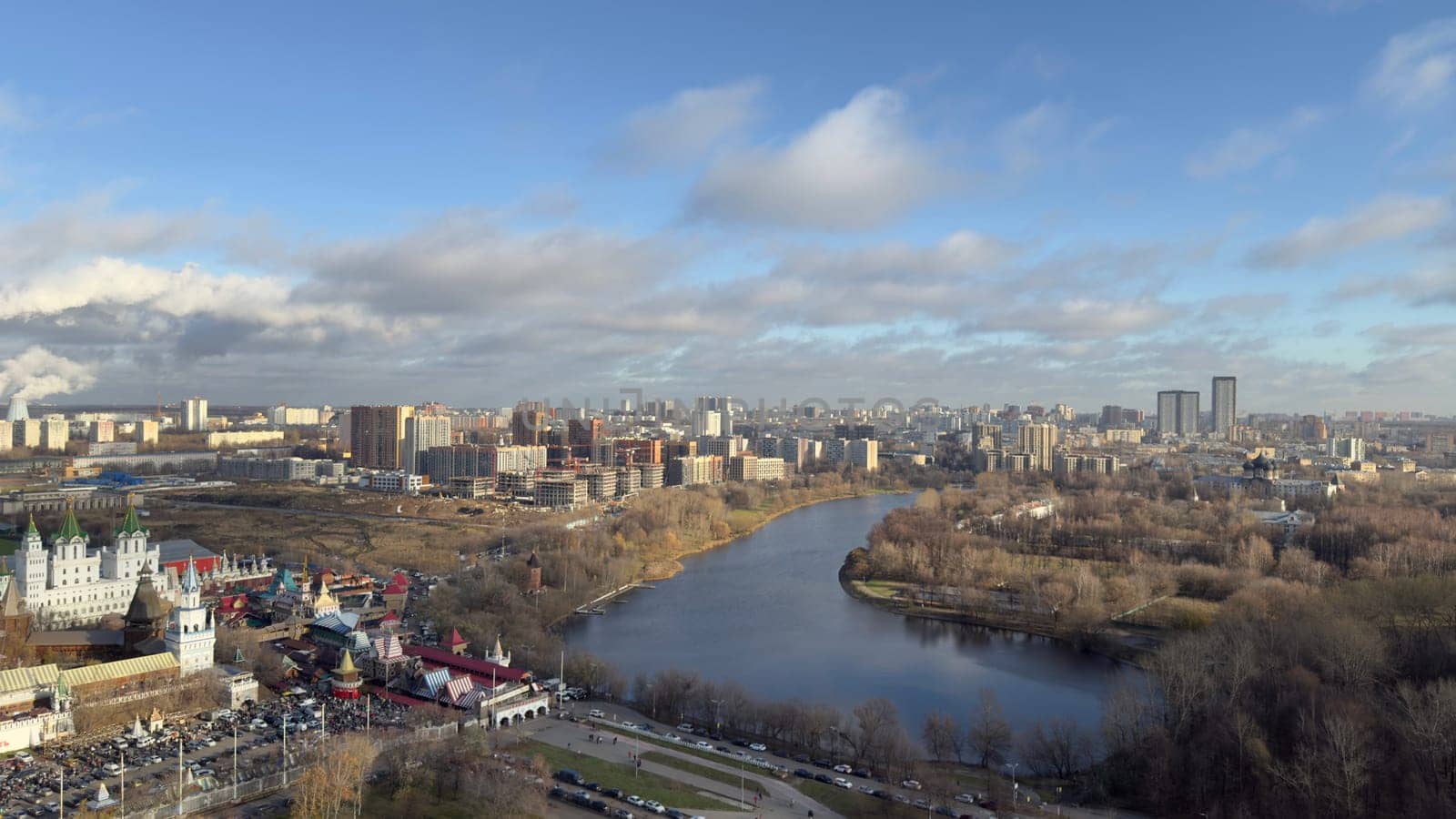 Panorama of Moscow from above overlooking buildings and pond on cold winter day, beautiful view of the capital of Russia in cold season with trees without foliage