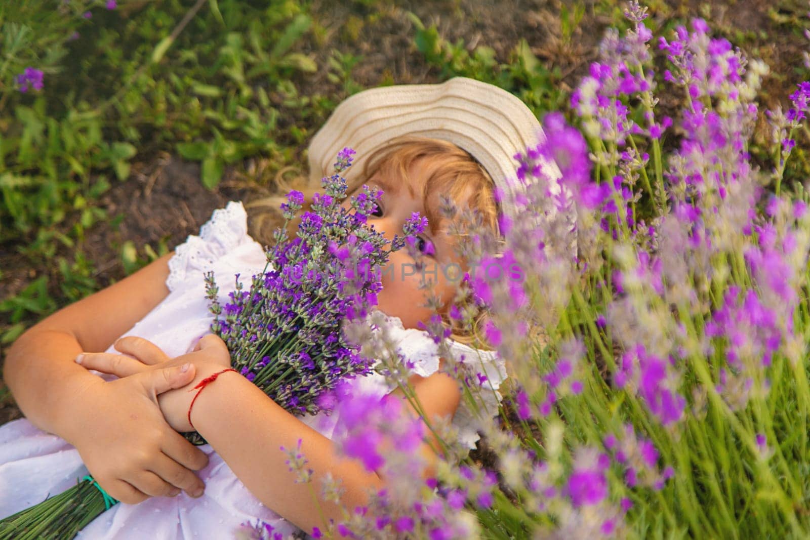 Child girl in lavender field. Selective focus. Kid.