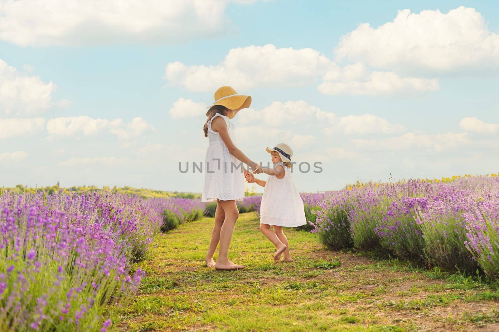 Child girl in lavender field. Selective focus. Kid.