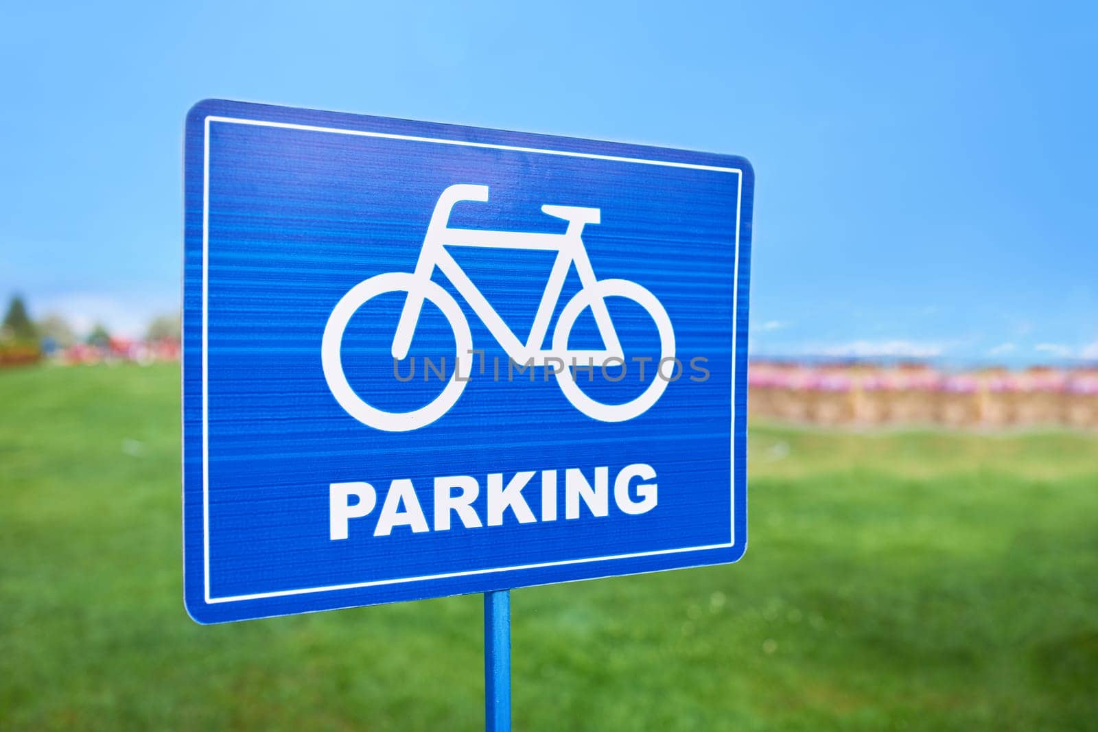 A sky blue traffic sign with a bicycle wheel design on it. The font is bold and eyecatching, drawing attention to the presence of bicycle lanes in the area
