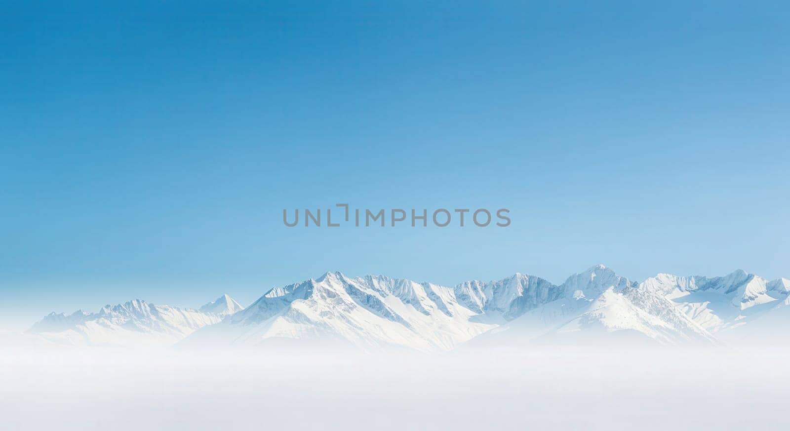 Panoramic view of majestic snow-capped mountains beneath a clear blue sky, evoking a sense of tranquility and vastness of nature. perfect for nature-themed designs and outdoor adventure promotions.