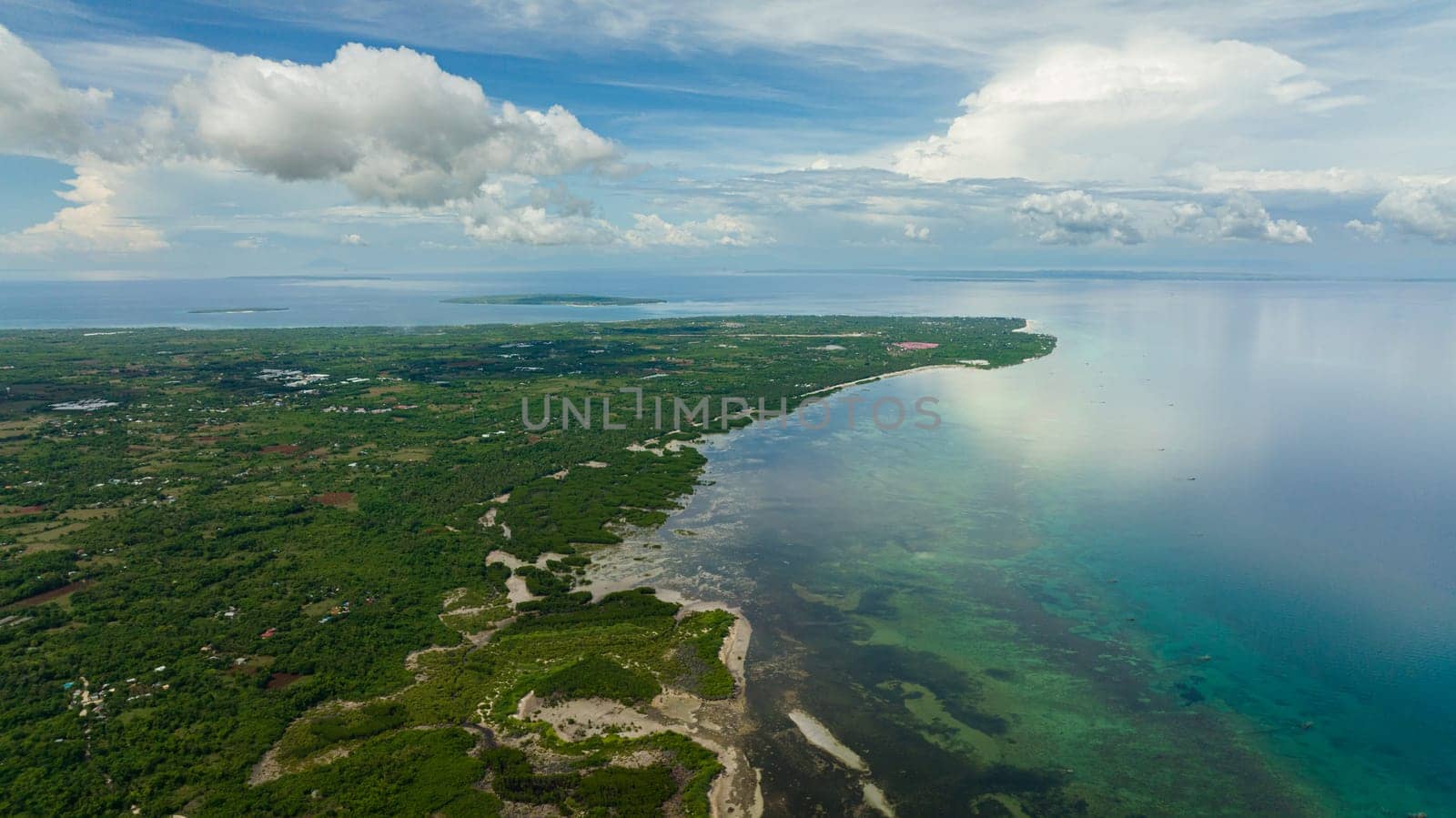 Tropical island against the blue sky and clouds. Bantayan island, Philippines.