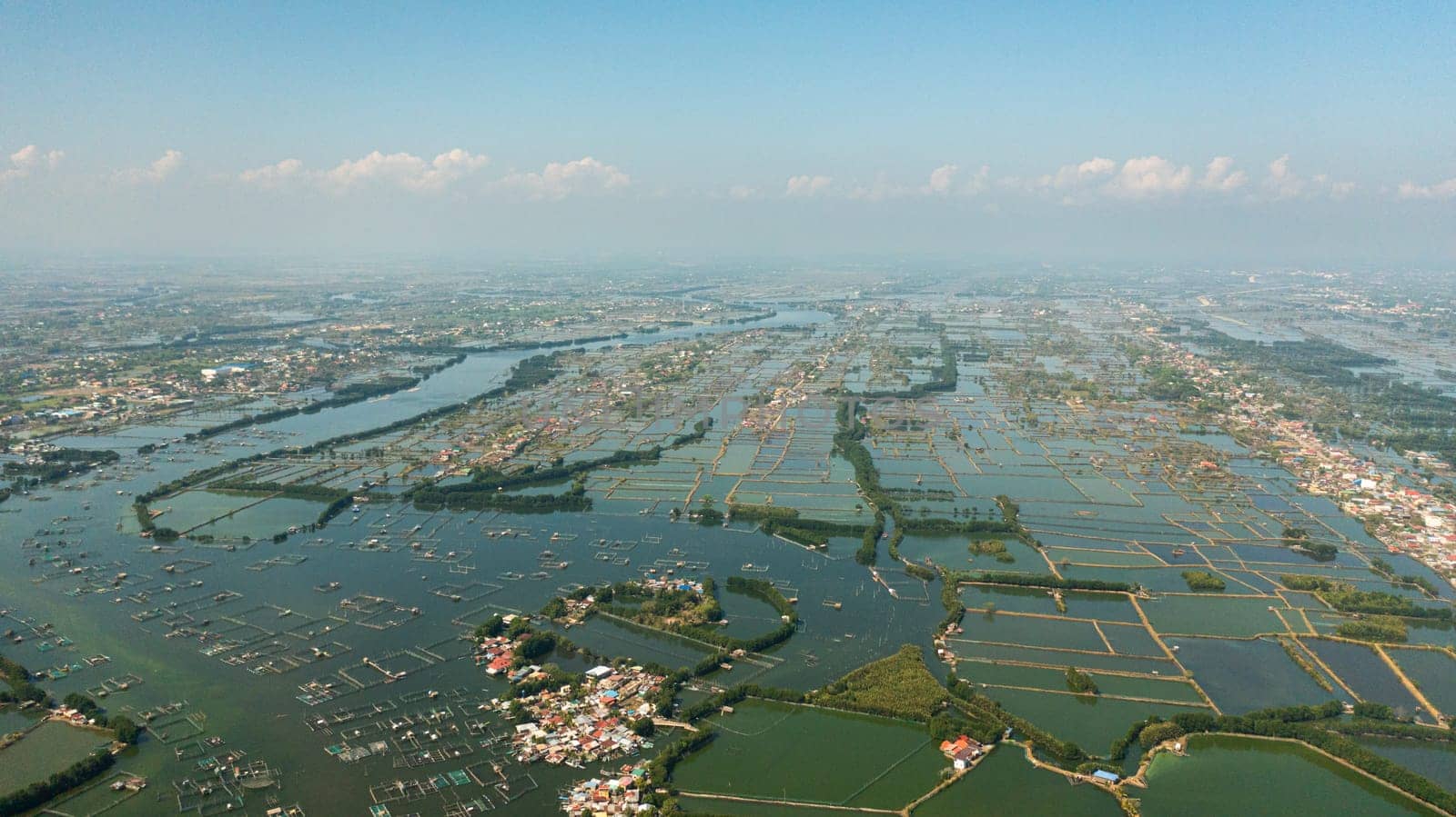 A town in a sea harbor with bridges and a river flowing into the sea.