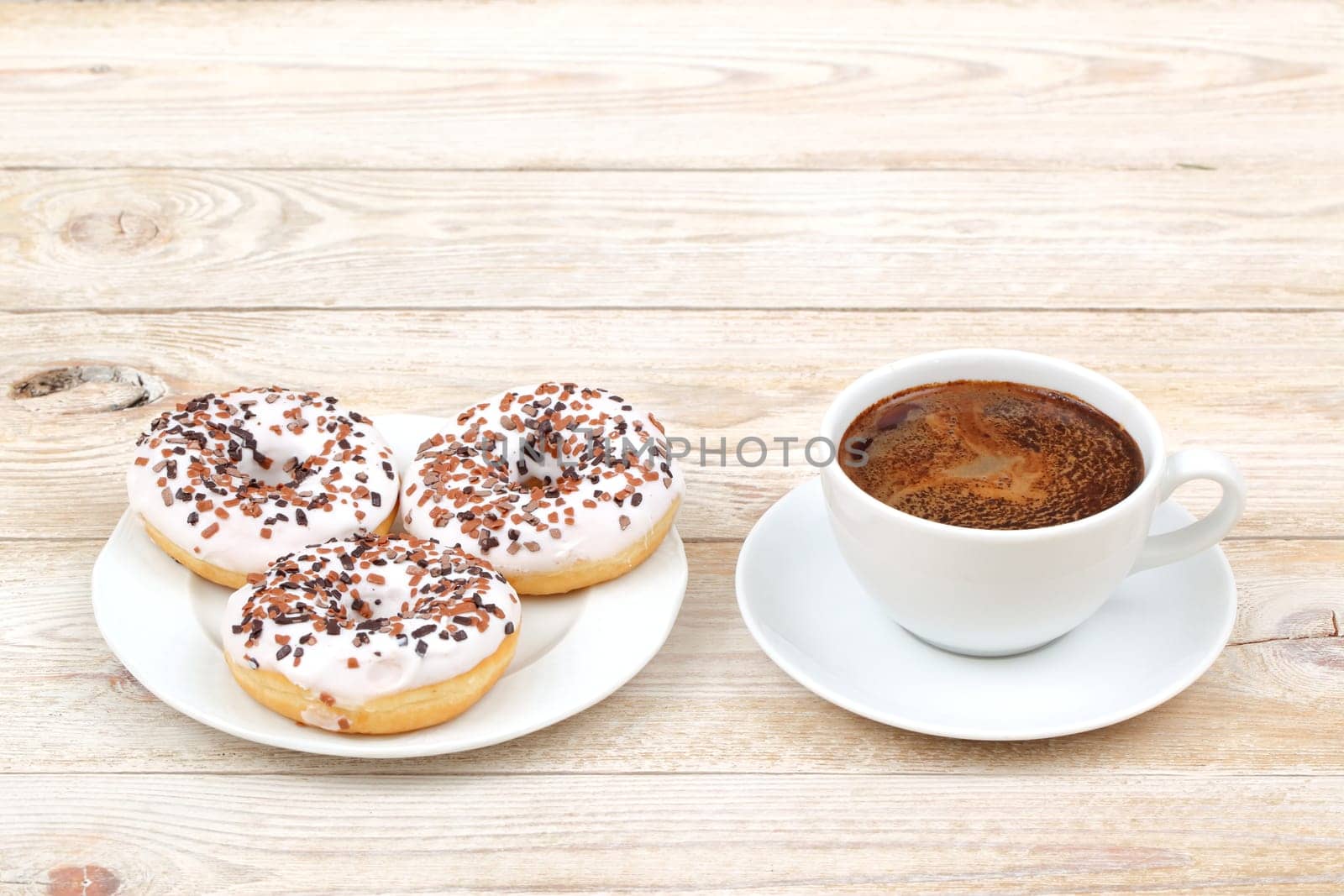 A tempting set of delicious donuts perfectly paired with a steaming cup of rich coffee, ideal for a cozy treat