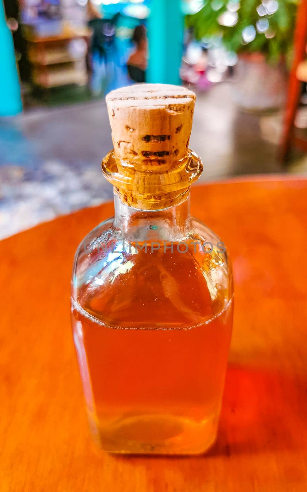 olive oil bottle dispenser on wooden table in Zicatela Puerto Escondido Oaxaca Mexico.