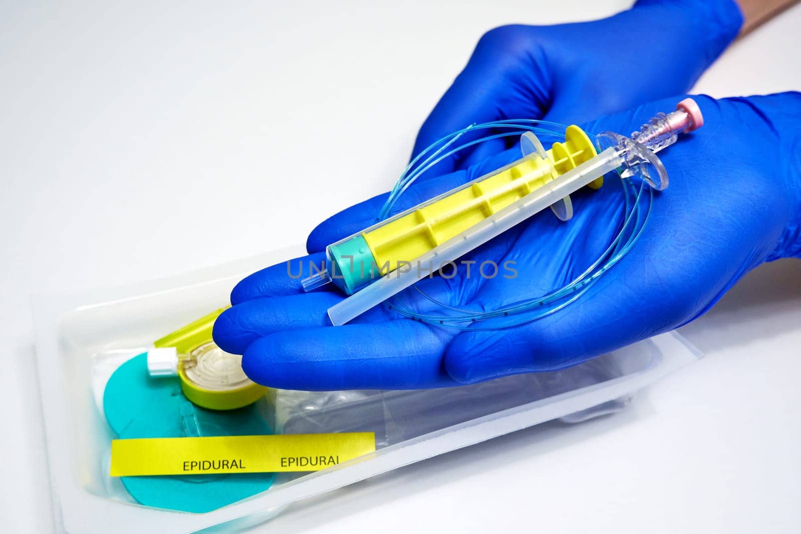 Modern disposable plastic kit for epidural anesthesia in the hands of a medic close-up