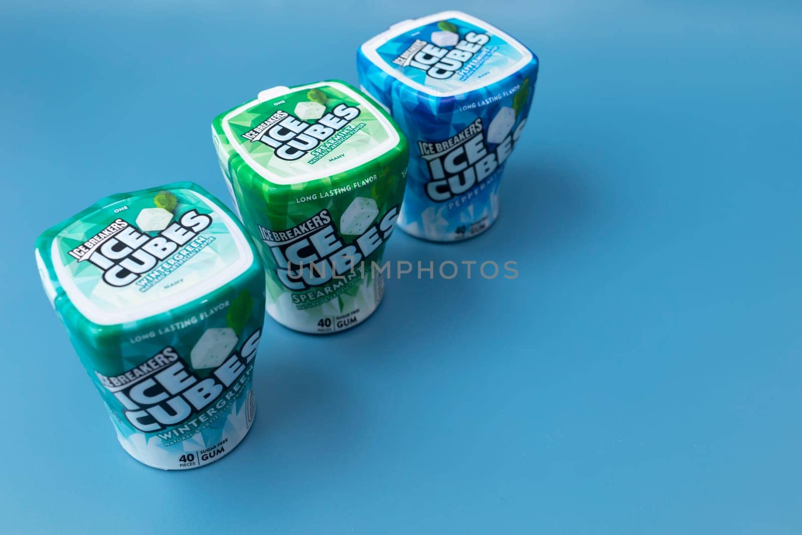 Few Packages Of Ice Cubed Bubble Gum. Healthy Sugar-Free Xylitol Chewing Cubes With Different Flavor on Blue Background. Healthy Teeth, Beautiful Smile. Copy Space. Horizontal. Phoenix,USA: 09.24.2023 by netatsi