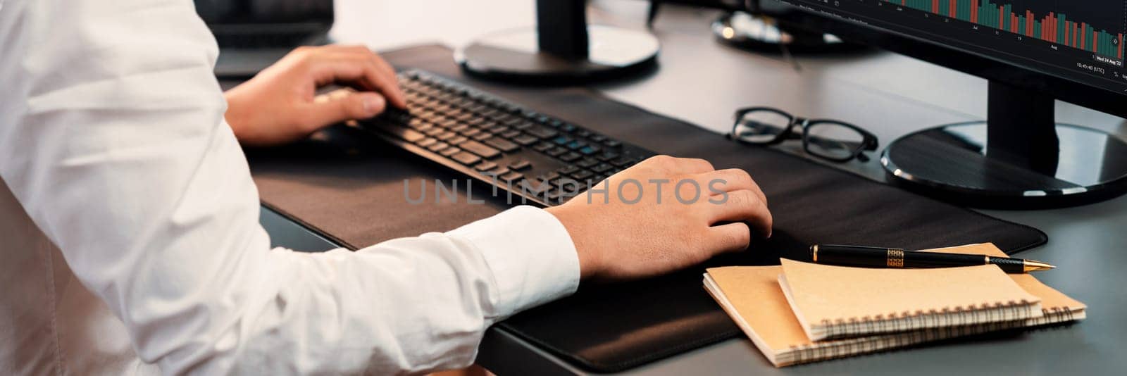 Office worker sitting on workspace desk typing on keyboard. Trailblazing by biancoblue