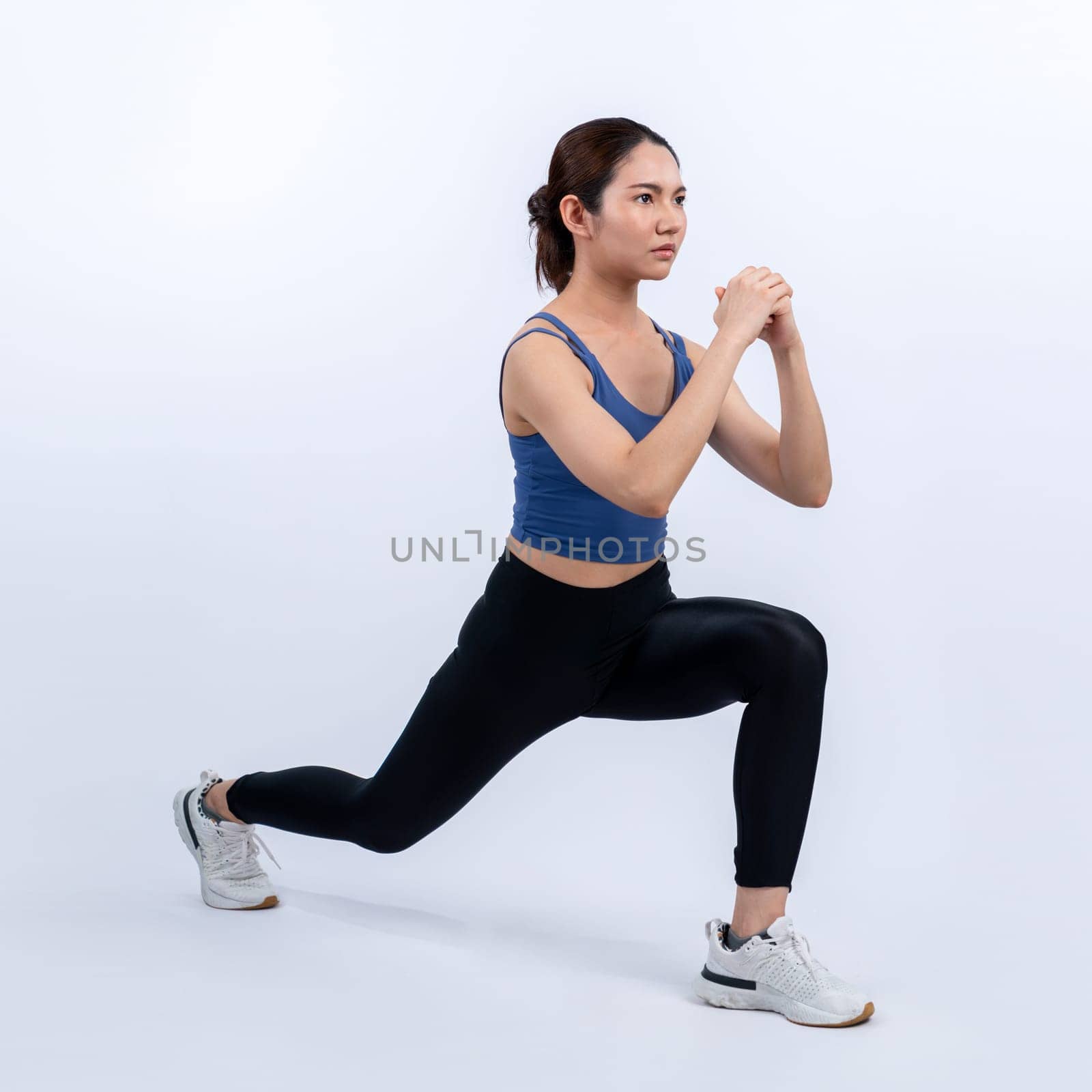 Young attractive asian woman in sportswear stretching before fitness exercise routine. Healthy body care workout with athletic woman warming up on studio shot isolated background. Vigorous