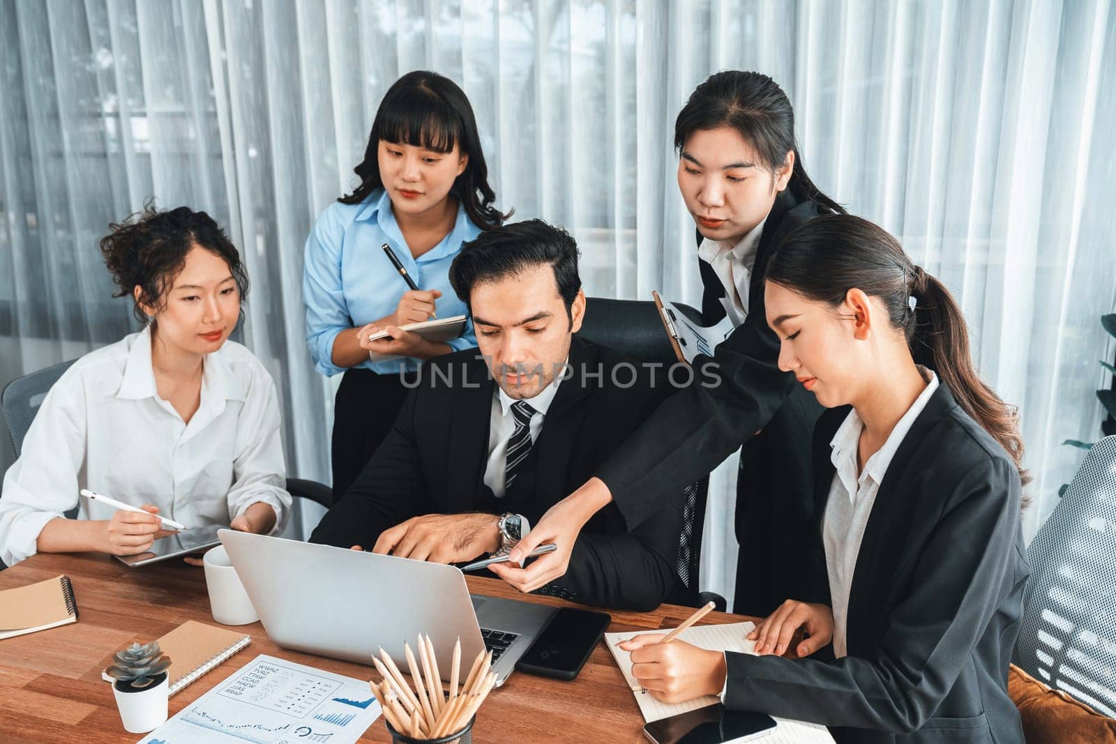 Diverse of business people from various ethnic group working in modern office environment. Productive and multi ethnic office workers engage in discussion for strategic business marketing. Meticulous