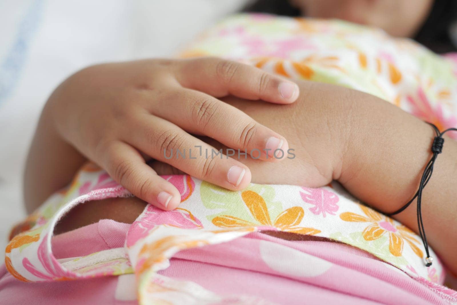 a child sleeping in bed, selective focus on hand .